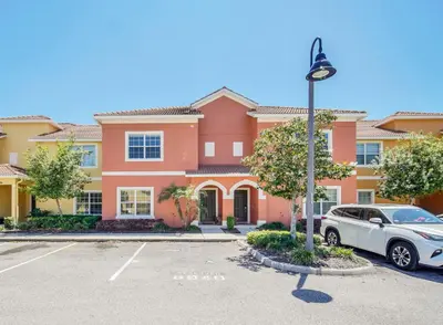 a house with a car parked in a parking lot at Ev8940 - Magic Palms Retreat in Kissimmee
