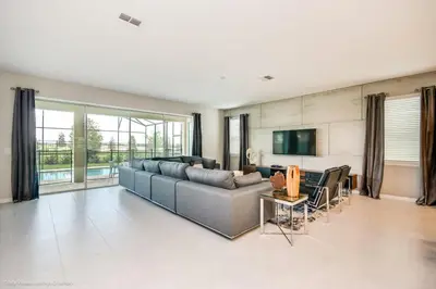 a living room with a couch and a tv at Ev9043 - Solara Prestige Villa in Orlando