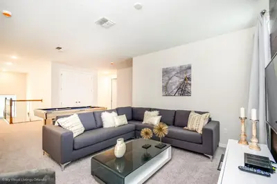 a living room with a couch and a table at Ev9043 - Solara Prestige Villa in Orlando