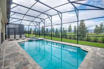 an indoor swimming pool with a glass roof at Ev9043 - Solara Prestige Villa in Orlando