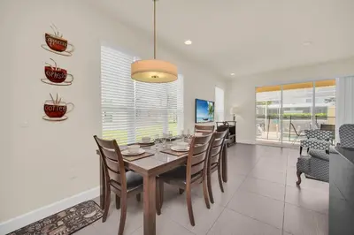 a dining room with a table and chairs at Ev1447 - The Retreat Villa in Orlando