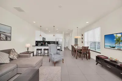 a living room with a couch and a dining room at Ev1447 - The Retreat Villa in Orlando