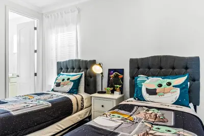 two beds with hello kitty pillows in a bedroom at Ev1472 - Reunion Getaway in Orlando