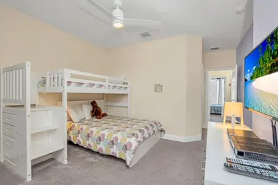 a bedroom with a bunk bed and a desk at Ev1511 - The Serenity Villa in Orlando