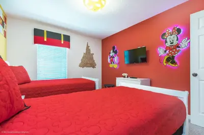 a bedroom with a red bed and a red couch at Ev1542 - Solara Luxe in Orlando