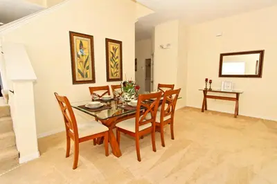 a dining room with a table and chairs at Ev1915 - Sunset Glen Villa in Orlando