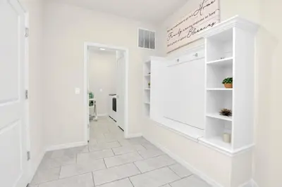 a hallway with white walls and white shelves at Ev2010 - Windsor Star Retreat in Kissimmee