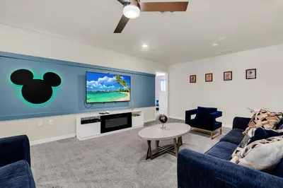 a living room with a couch and a tv at Ev2010 - Windsor Star Retreat in Kissimmee