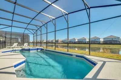 an indoor swimming pool with a large glass building at Ev2395 - Grand Haven Retreat in Kissimmee