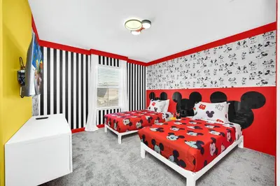 a bedroom with two beds and a red wall at Ev2444 - Palm Breeze Escape in Kissimmee