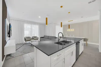 a kitchen with a sink and a living room at Ev2444 - Palm Breeze Escape in Kissimmee