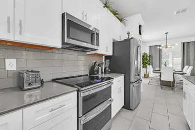 a kitchen with a stove and a refrigerator at Ev2529 - Grand Orchid Retreat in Kissimmee