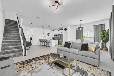 a living room with a couch and a table at Ev2529 - Grand Orchid Retreat in Kissimmee