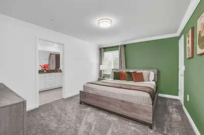 a bedroom with a bed and a green wall at Ev2529 - Grand Orchid Retreat in Kissimmee
