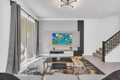 a living room with a couch and a table at Ev2529 - Grand Orchid Retreat in Kissimmee