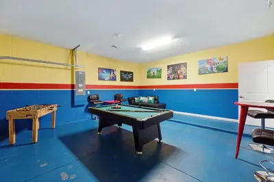 a room with a pool table and a table at Ev2576 - Lakeside Adventure Villa in Kissimmee
