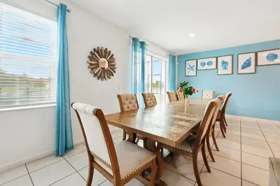 a dining room with a wooden table and chairs at Ev2576 - Lakeside Adventure Villa in Kissimmee