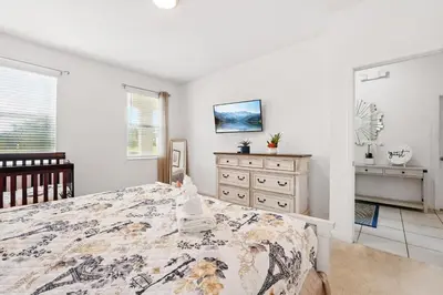 a bedroom with a bed and a dresser at Ev2576 - Lakeside Adventure Villa in Kissimmee