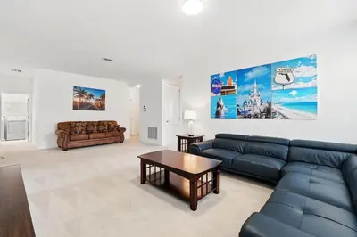 a living room with a couch and a table at Ev2576 - Lakeside Adventure Villa in Kissimmee