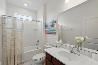 a white bathroom with a sink and a toilet at Ev2576 - Lakeside Adventure Villa in Kissimmee
