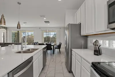 a kitchen with white counter tops and a refrigerator at Ev2613 - Grand Horizon Manor in Kissimmee