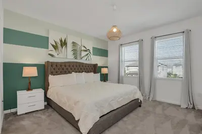 a bedroom with a large bed and two windows at Ev2613 - Grand Horizon Manor in Kissimmee