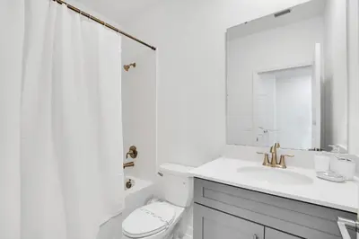 a white bathroom with a sink and a toilet at Ev2669 - Sunshine Escape Villa in Kissimmee