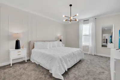 a white bedroom with a bed and a ceiling fan at Ev2669 - Sunshine Escape Villa in Kissimmee