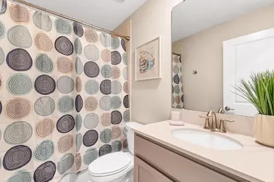 a bathroom with a toilet and a shower curtain at Ev2707 - Magic Getaway Villa in Kissimmee
