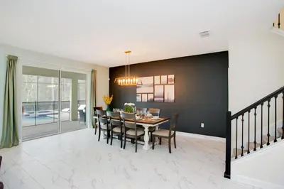 a dining room and living room with a table and chairs at Ev2709 - Enchanted Retreat Villa in Kissimmee