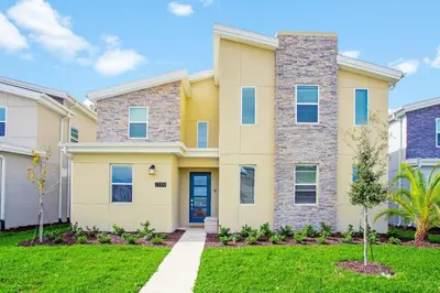 a house with a lawn in front of it at Ev2709 - Enchanted Retreat Villa in Kissimmee