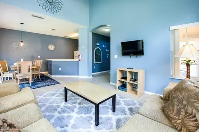 a living room with a couch and a table at Ev2739 - Emerald Serenity Villa in Kissimmee