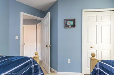 a bedroom with blue walls and a white door at Ev2739 - Emerald Serenity Villa in Kissimmee