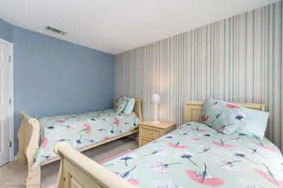 a bedroom with two beds and a night stand at Ev2739 - Emerald Serenity Villa in Kissimmee