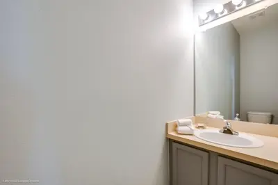 a bathroom with a sink and a mirror at Ev2739 - Emerald Serenity Villa in Kissimmee