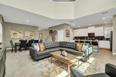 a living room with a couch and a table at Ev2755Book - Golden Horizon Villa in Kissimmee