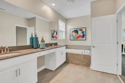 a white bathroom with two sinks and a tub at Ev2755Book - Golden Horizon Villa in Kissimmee