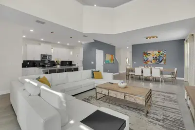 a living room with a white couch and a table at Ev2775 - Majestic Escape Villa in Kissimmee
