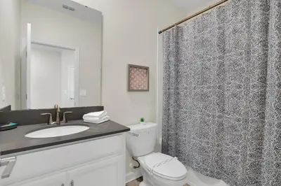 a bathroom with a toilet and a shower curtain at Ev2775 - Majestic Escape Villa in Kissimmee