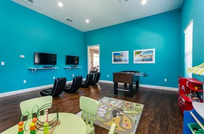 a play room with blue walls and a table and chairs at Ev014 - Lucaya Retreat in Kissimmee