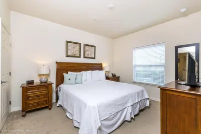 a bedroom with a bed and a television at Ev014 - Lucaya Retreat in Kissimmee