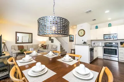 a kitchen and living room with a table and chairs at Ev014 - Lucaya Retreat in Kissimmee
