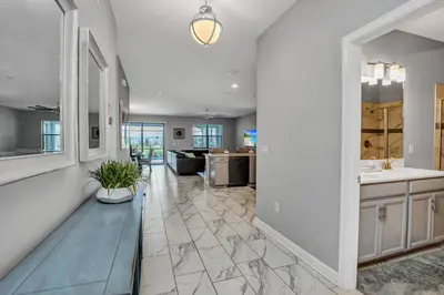 a living room with a bench and a kitchen at Ev2909 - Storey Lake Haven in Kissimmee