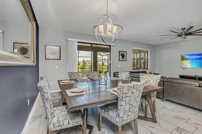 a dining room with a wooden table and chairs at Ev2909 - Storey Lake Haven in Kissimmee