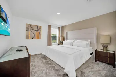 a white bedroom with a large bed and a window at Ev2989 - Serenity Palms Villa in Kissimmee