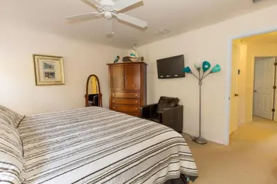 a bedroom with a bed and a ceiling fan at Ev3000 - Paradise Hideaway in Orlando