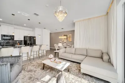 a living room with a couch and a table at Ev3007 - Lakeside Escape Villa in Kissimmee