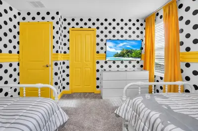 two beds in a bedroom with yellow doors and polka dots at Ev3009 - Grand View Retreat in Kissimmee