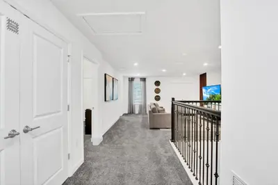 a hallway with white walls and a white door at Ev3009 - Grand View Retreat in Kissimmee