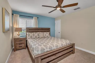 a bedroom with a bed and a ceiling fan at Ev3097 - Lakeside Serenity Villa in Kissimmee